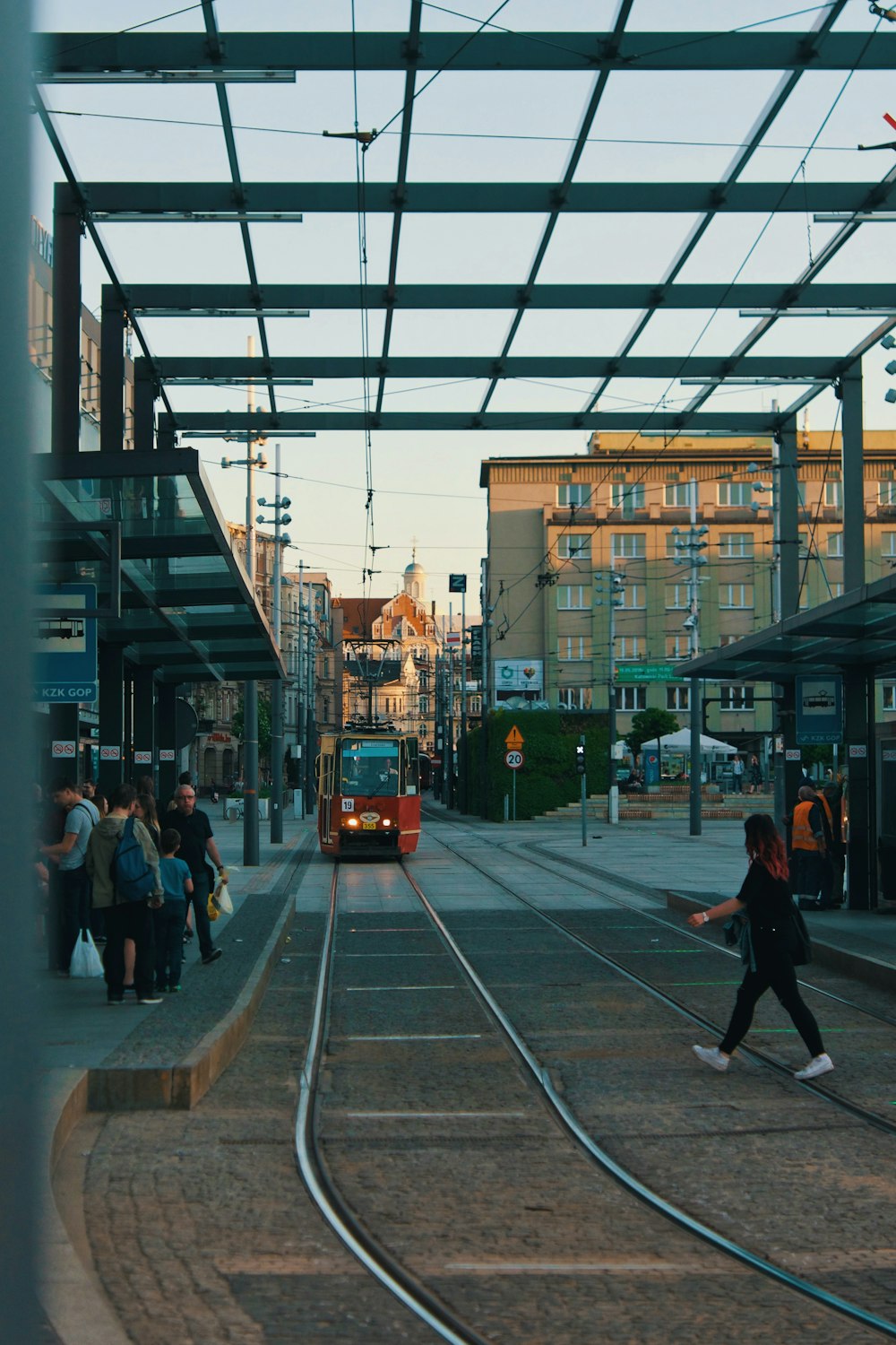 a group of people standing on a train track