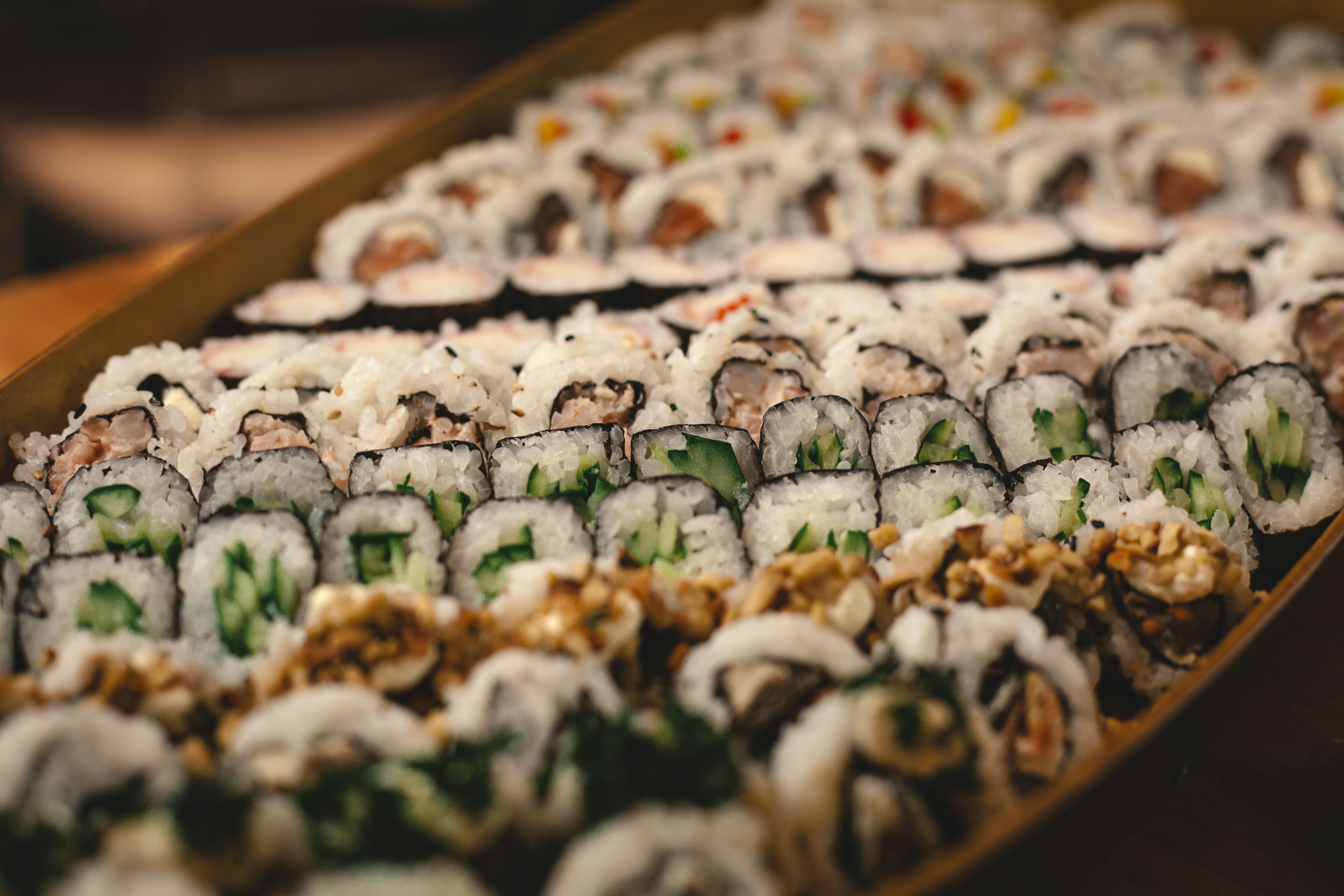 Plate of assorted sushi on a dark table