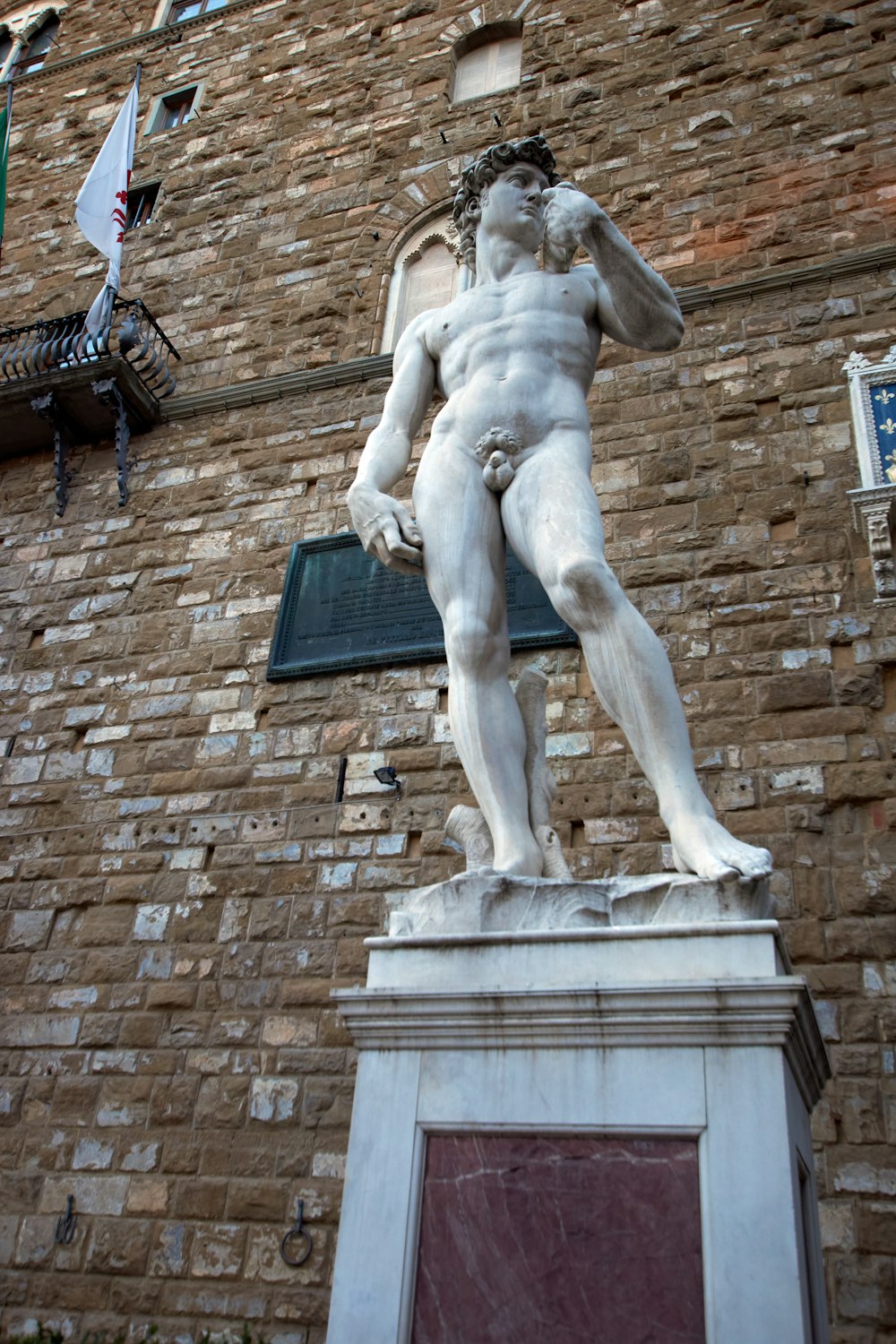 statue of man on brown brick wall