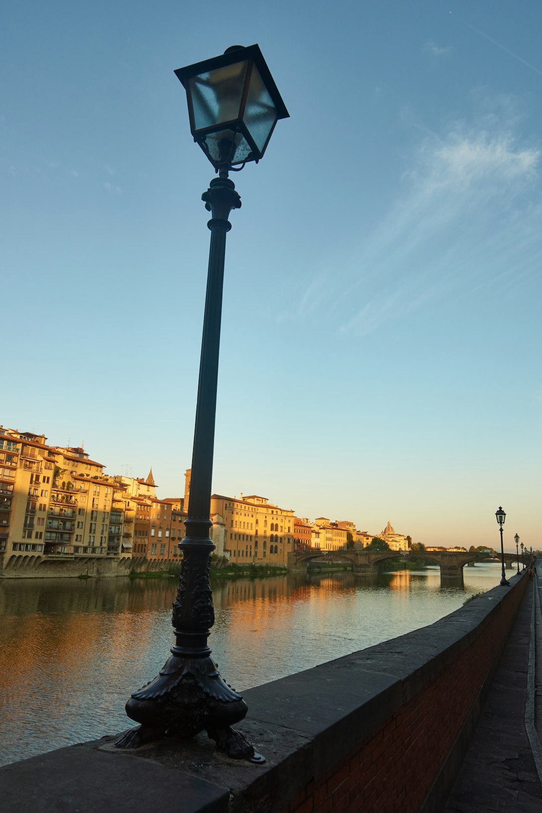 black street lamp near river during daytime