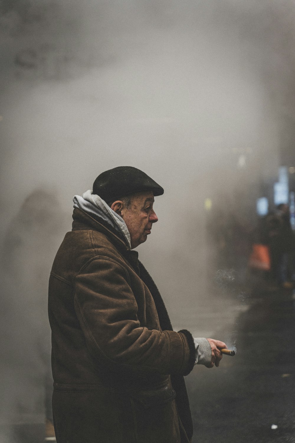 a man standing on a street next to a train