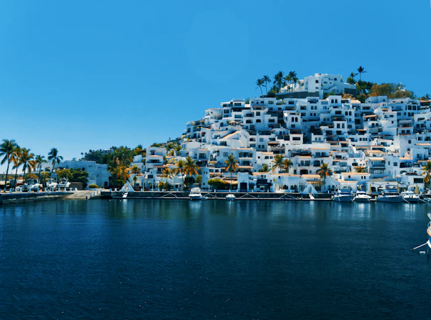 city buildings near body of water during daytime