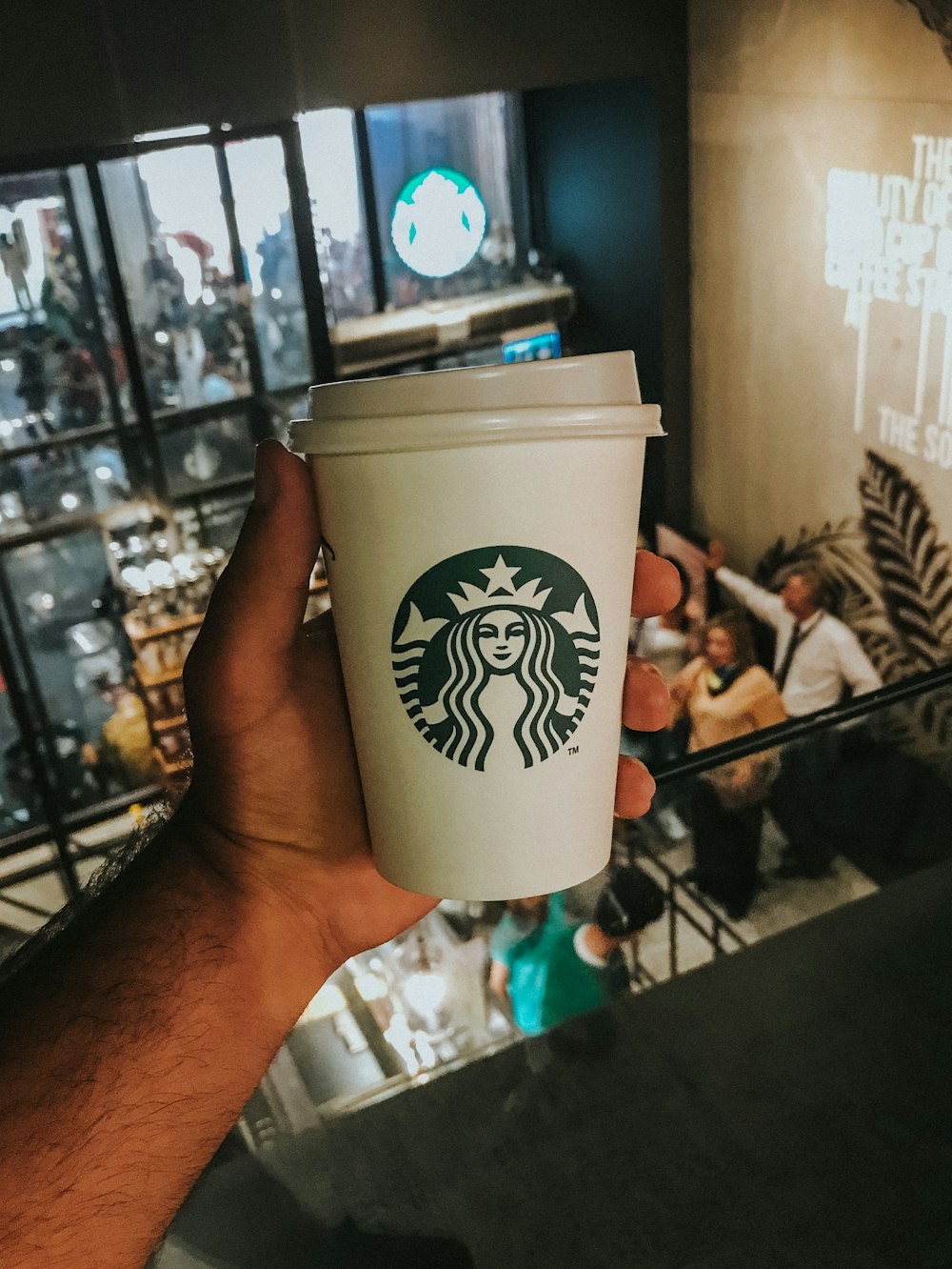 white and green starbucks disposable cup