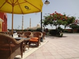 Outdoor seating area with traditional Islamic patterns and comfortable chairs.