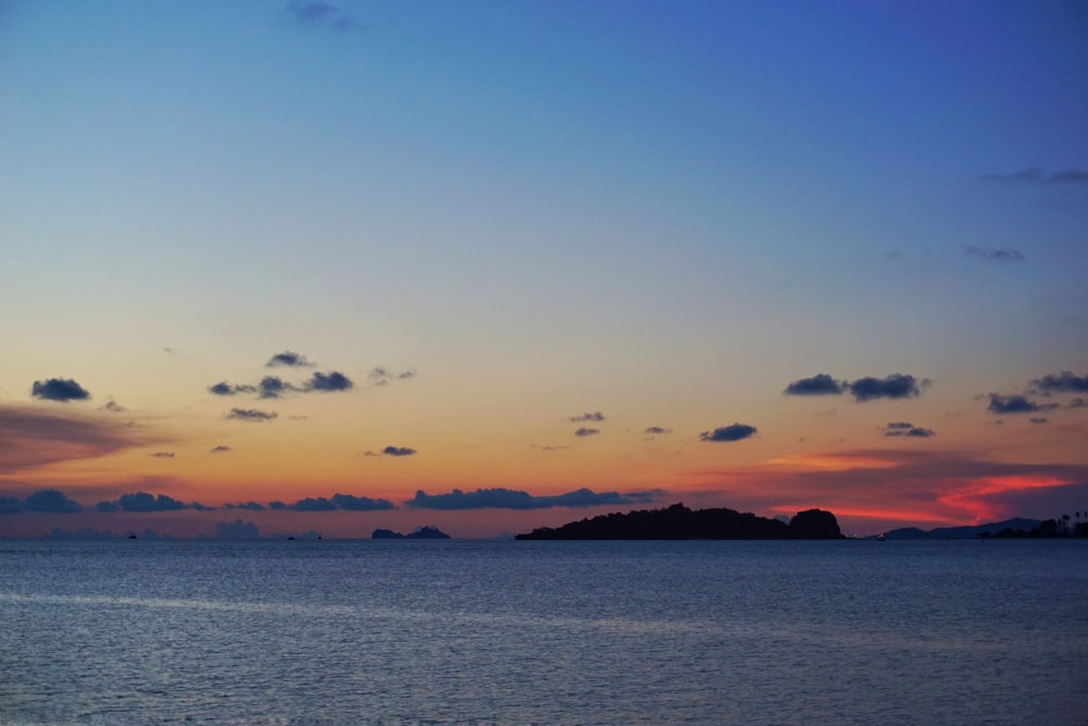 body of water during sunset