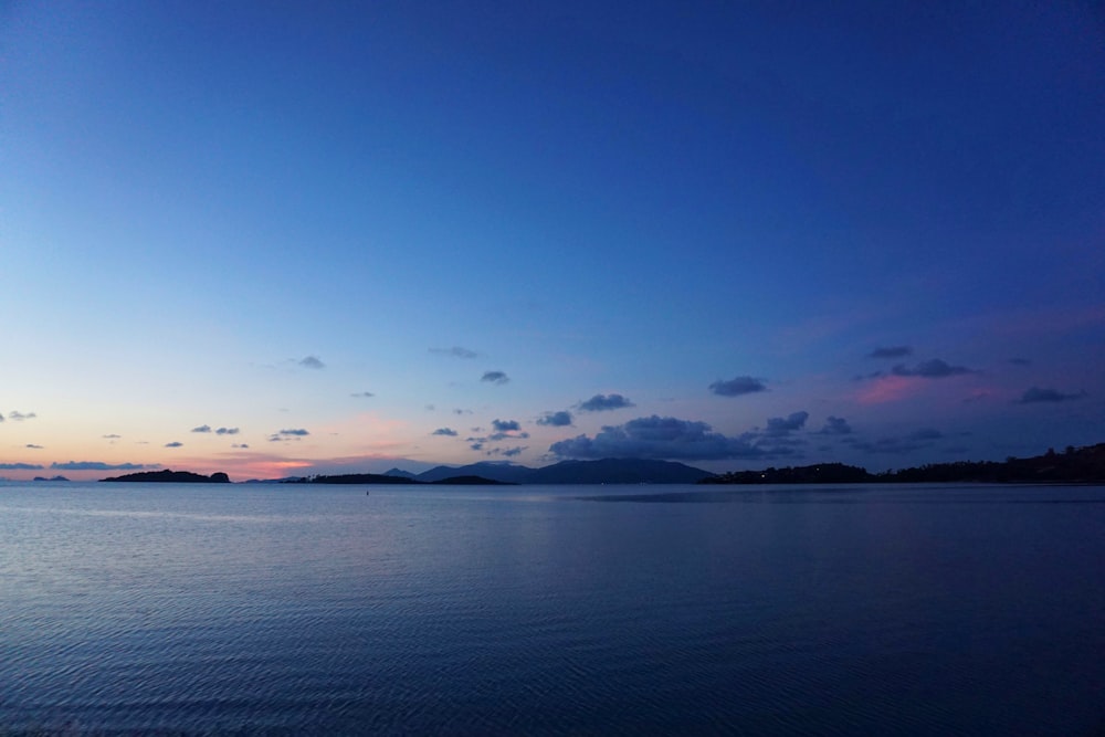 body of water under blue sky during daytime