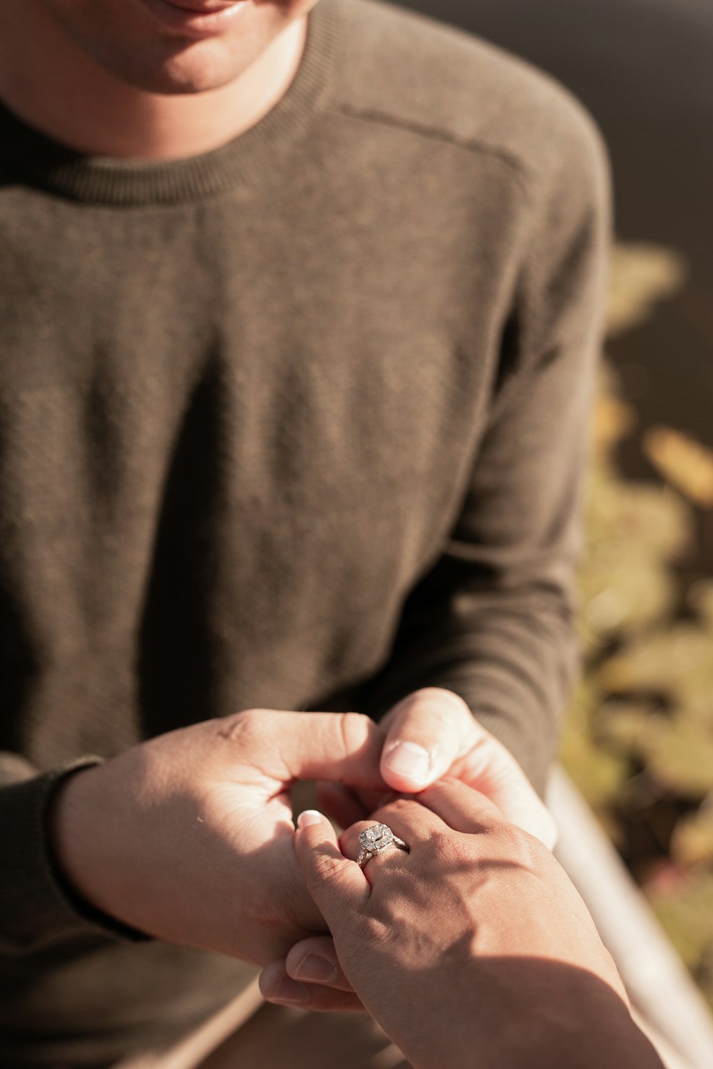 person holding silver and red gemstone ring