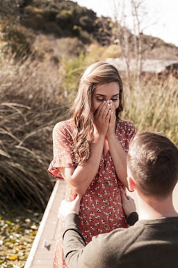 the knee,how to photograph woman's reaction to a proposal on the lake in san marcos, ca. these two friends of mine are both in the military, and are some of the most photogenic people i have ever met!; woman in red and white polka dot dress sitting on white wooden chair