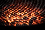 A grill with glowing coconut charcoal briquettes ready for cooking.
