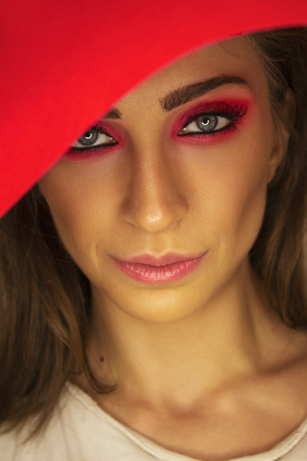 woman in red lipstick and black mascara