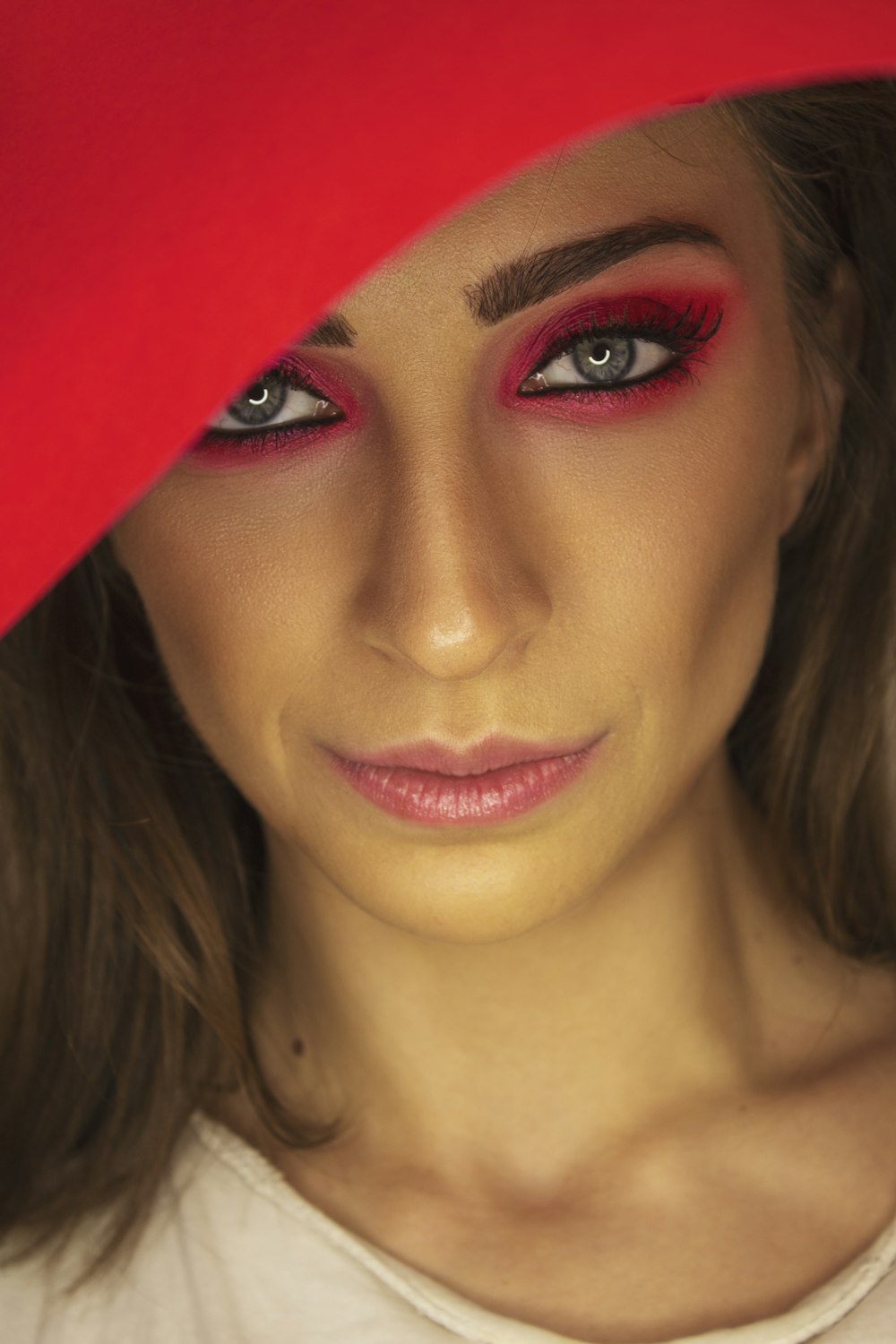 woman in red lipstick and black mascara