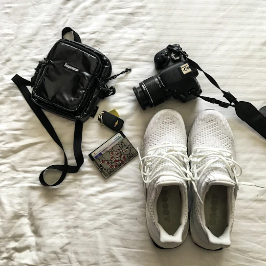 Close-up of stylish, modern accessories laid out on a clean white surface.