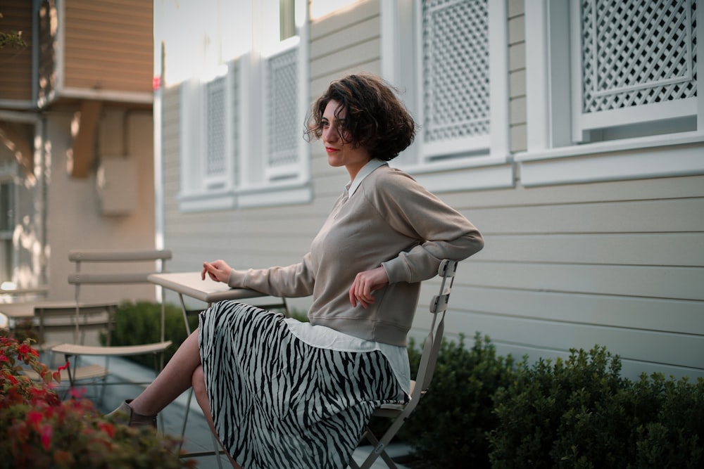 woman in white long sleeve shirt sitting on chair