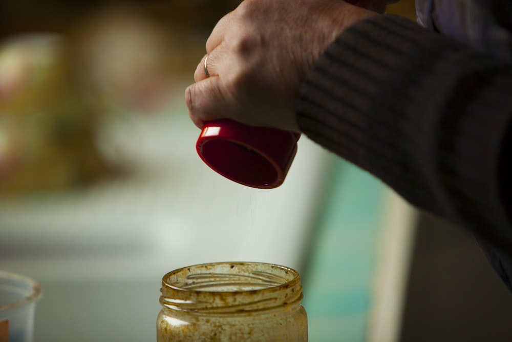 person holding red plastic cup