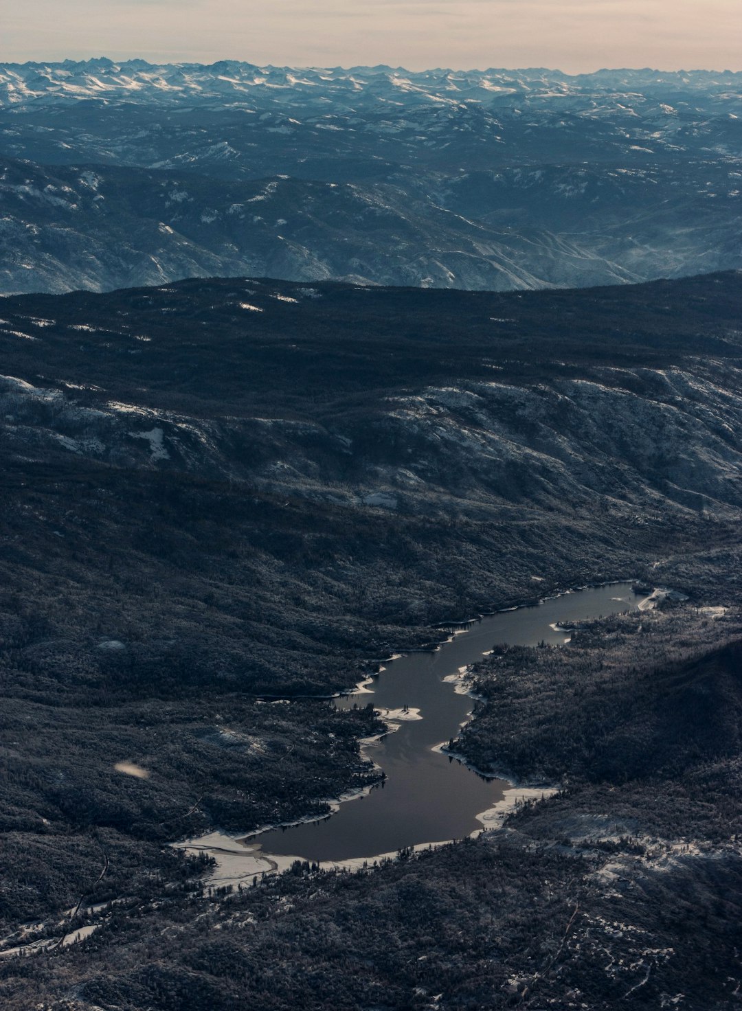 aerial view of lake in the middle of mountains