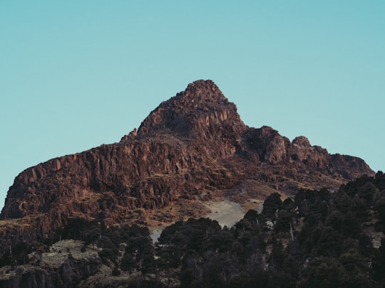 brown rocky mountain under blue sky during daytime in Volcán de Colima Mexico