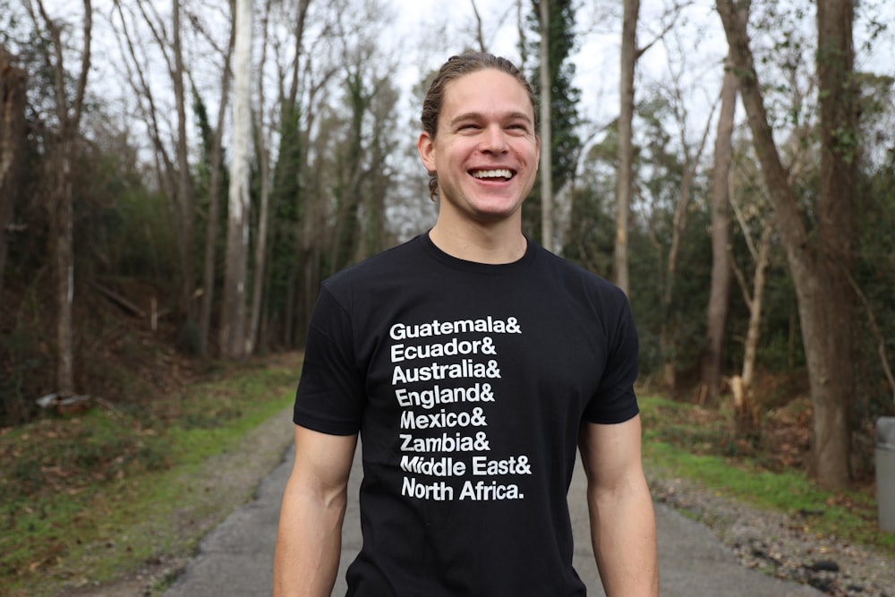 man in black crew neck t-shirt standing on pathway