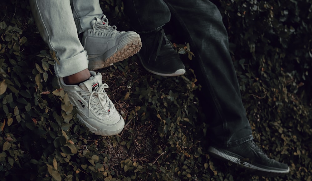 person in blue denim jeans and white nike sneakers