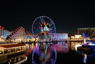 ferris wheel near body of water during night time