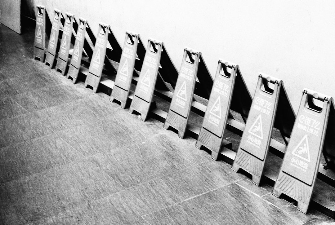 grayscale photo of white wooden blocks on concrete floor