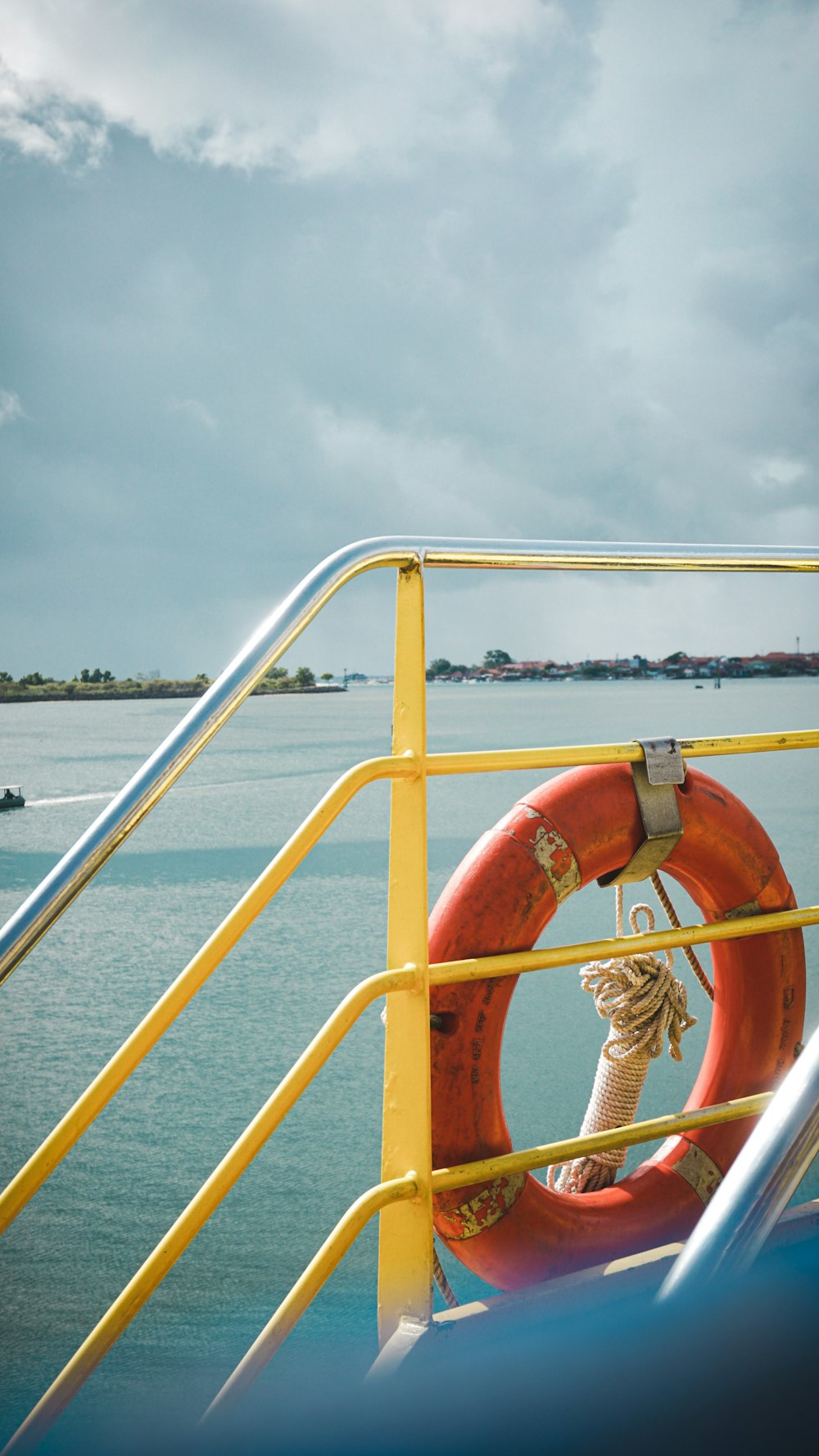 orange life buoy on white metal railings