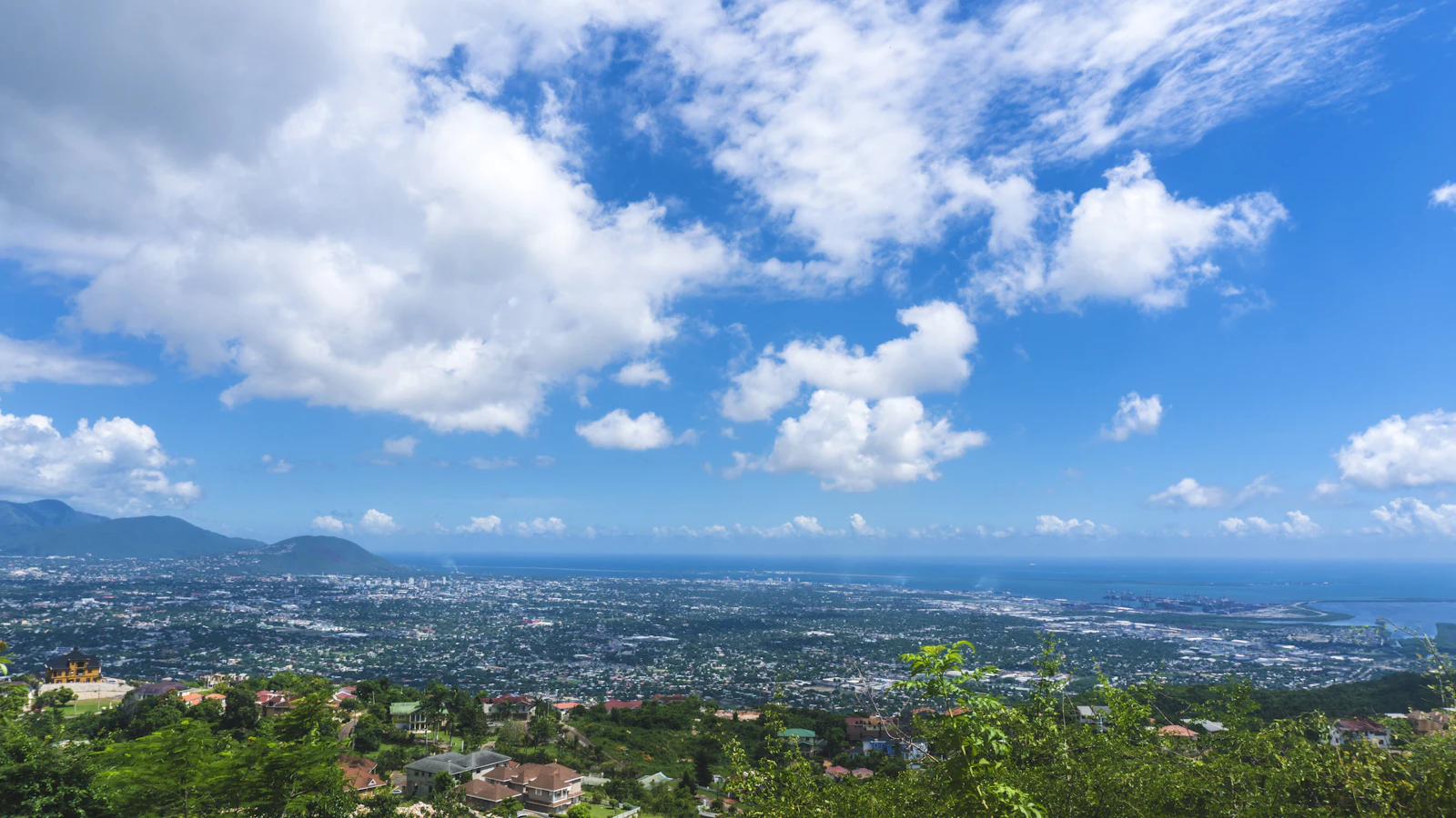 Aerial view of Kingston, Jamaica cityscape under blue sky, representing the Caribbean's AI policy and business landscape