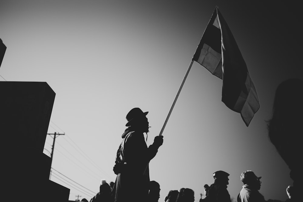 silhouette of people holding flags