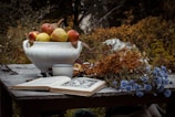A rustic table set with homemade preserves and a notebook filled with recipe ideas.