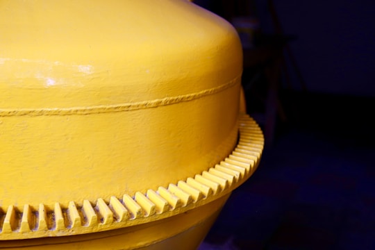 Close-up of durable yellow machinery parts neatly arranged on a workshop table.