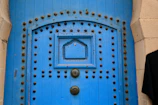 A sturdy steel door painted in deep blue, showcasing durability.