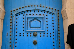 Sleek contemporary wooden door painted in vibrant blue with minimalist hardware