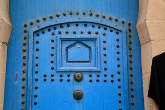 Sleek contemporary wooden door painted in vibrant blue with minimalist hardware