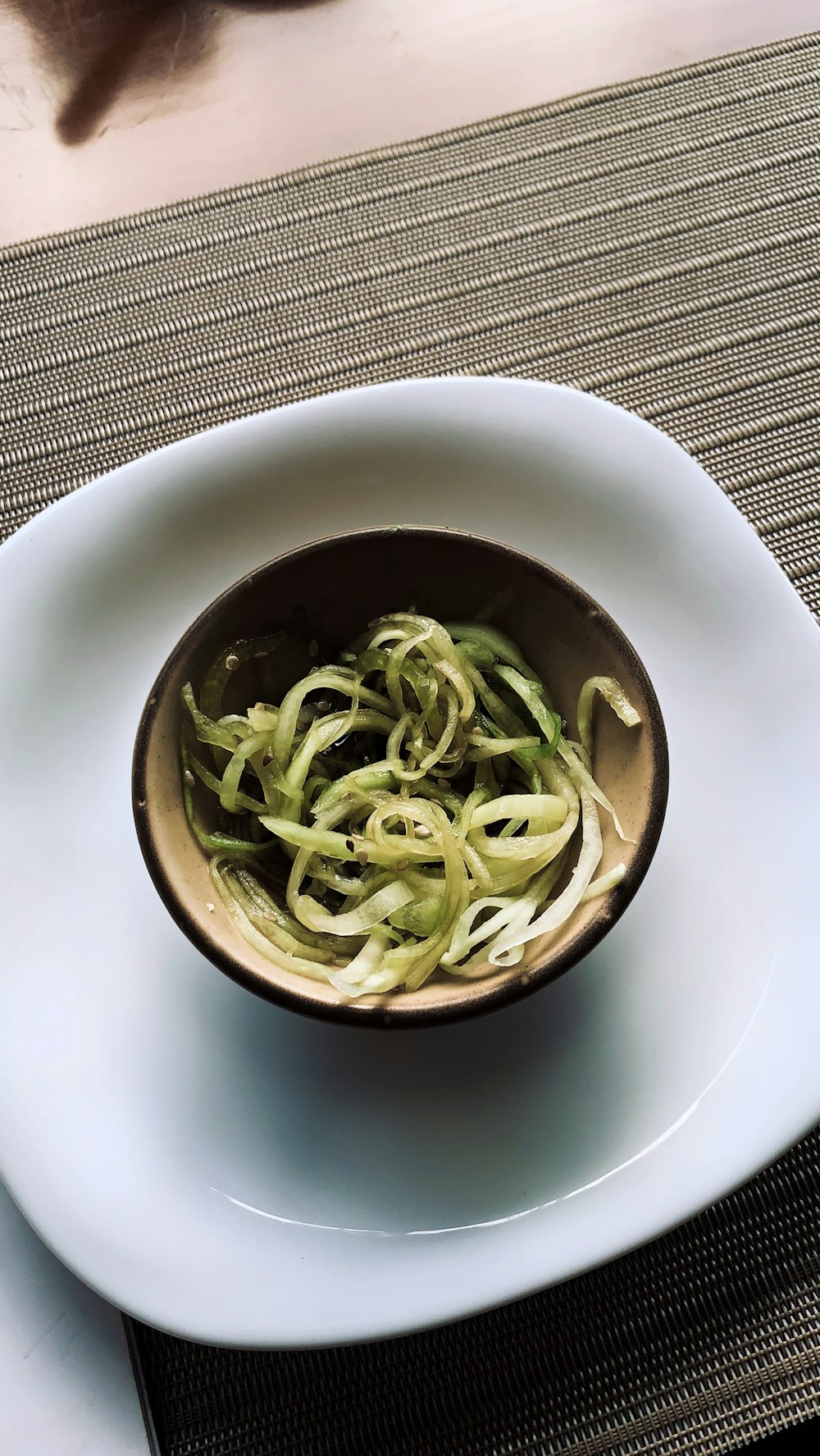 white ceramic bowl with green leaves