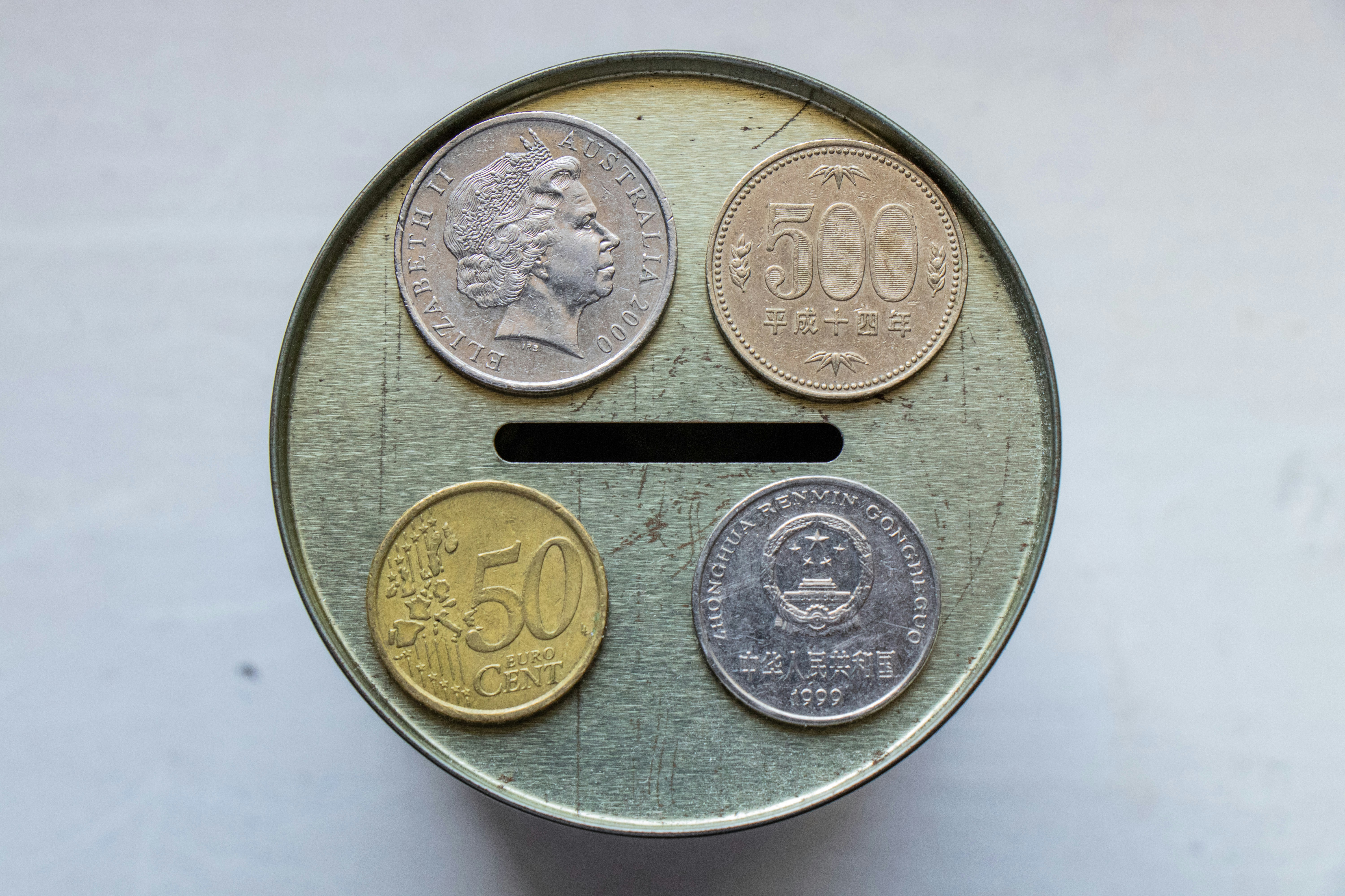 Coins from top to bottom, left to right: Australian 20 Cent, Japanese 500 Yen, Euro 50 Cent, Chinese 1 Yuan