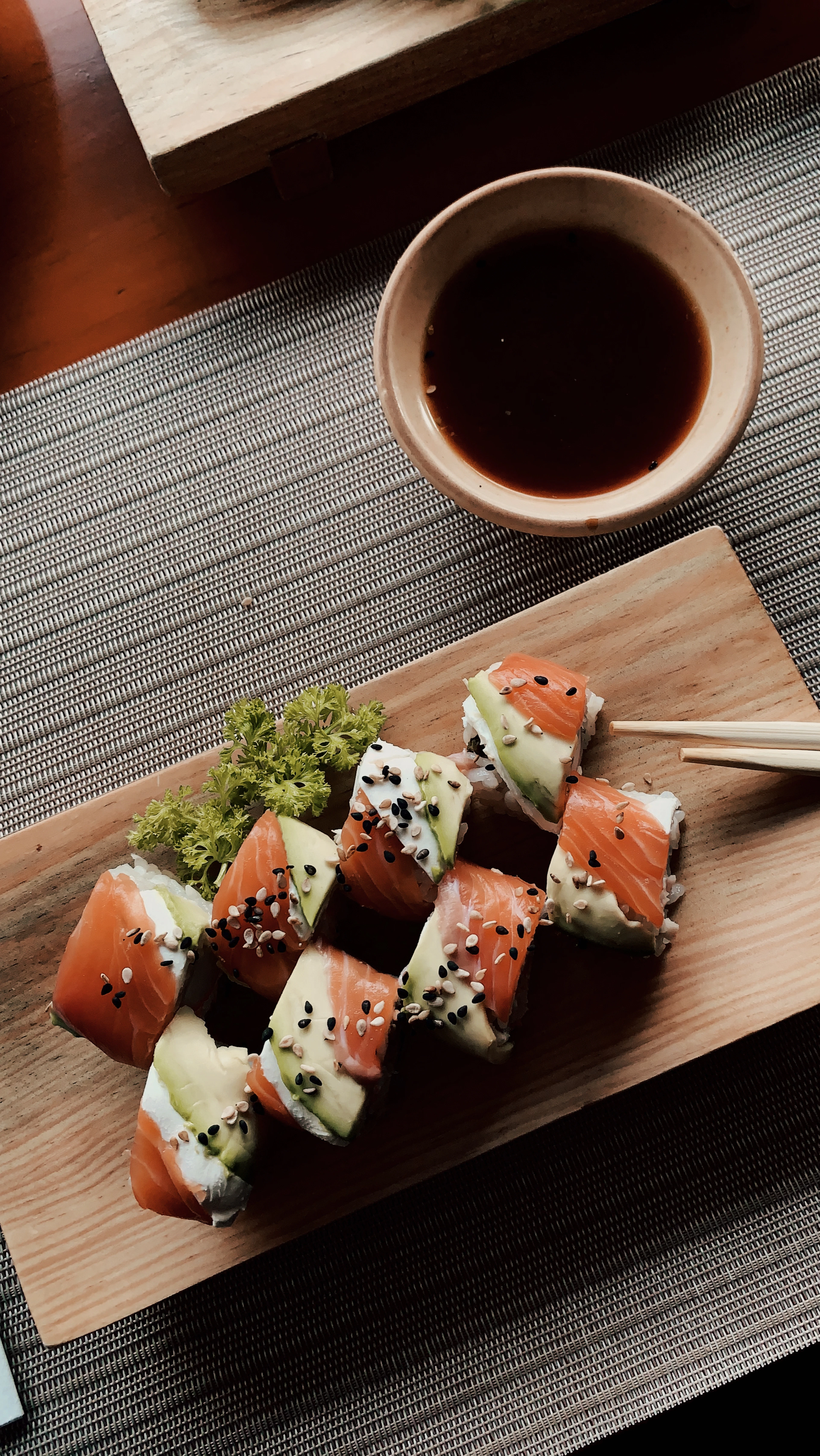 A sushi roll in extreme close-up, seeds on the rice