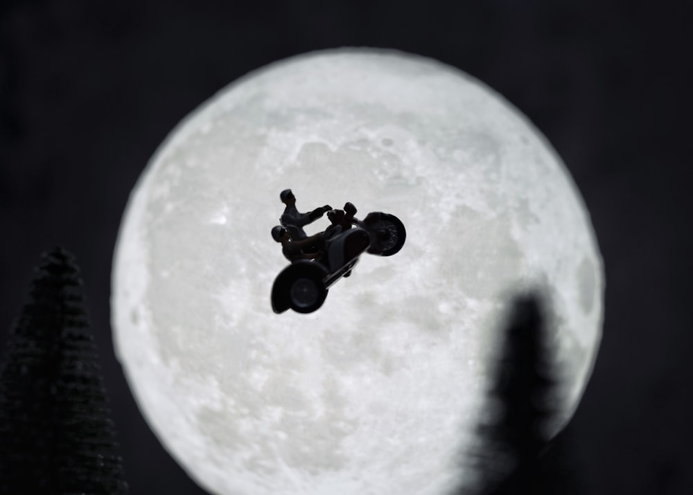 black and white robot toy on white moon