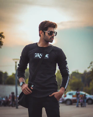 man in black long sleeve shirt wearing black sunglasses