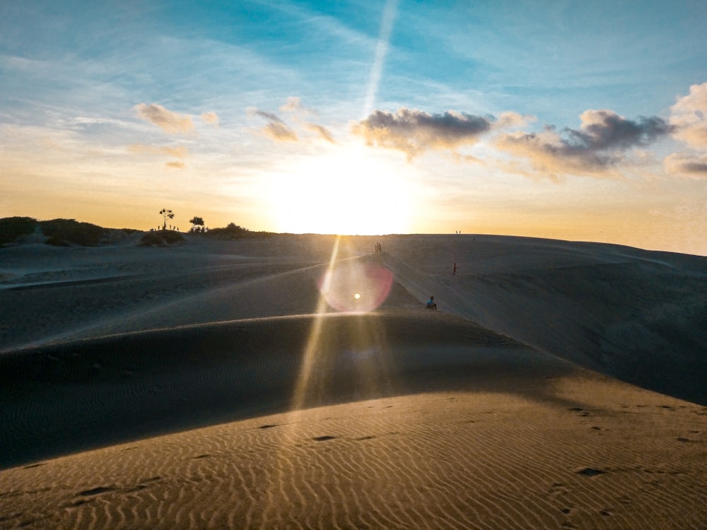 person walking on sand during daytime