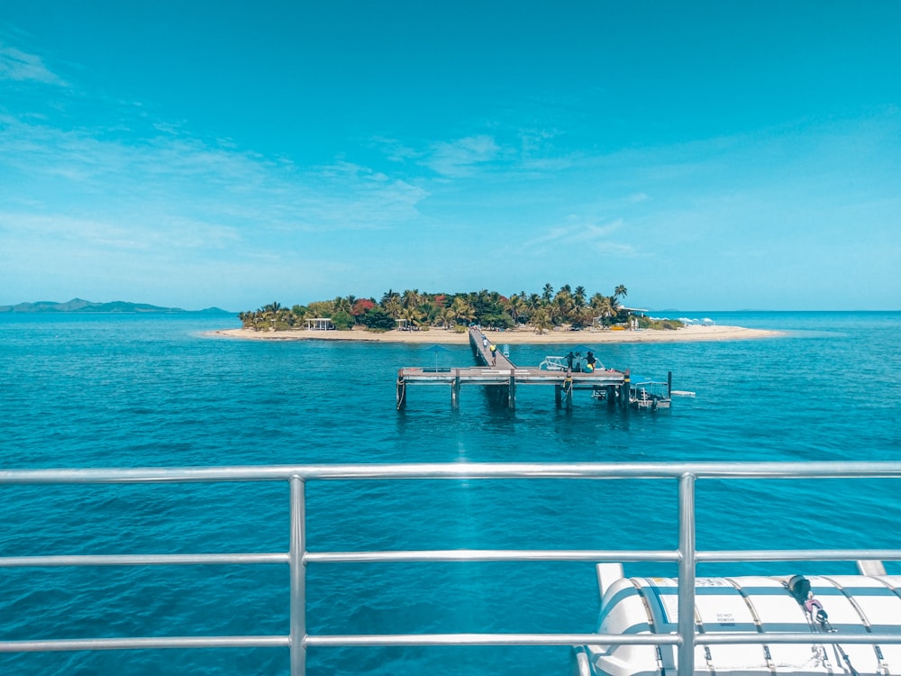 white and blue boat on sea during daytime