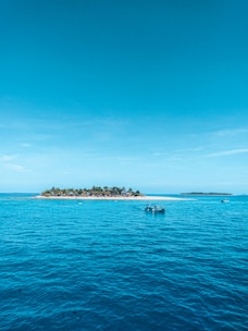 people riding on boat on sea during daytime