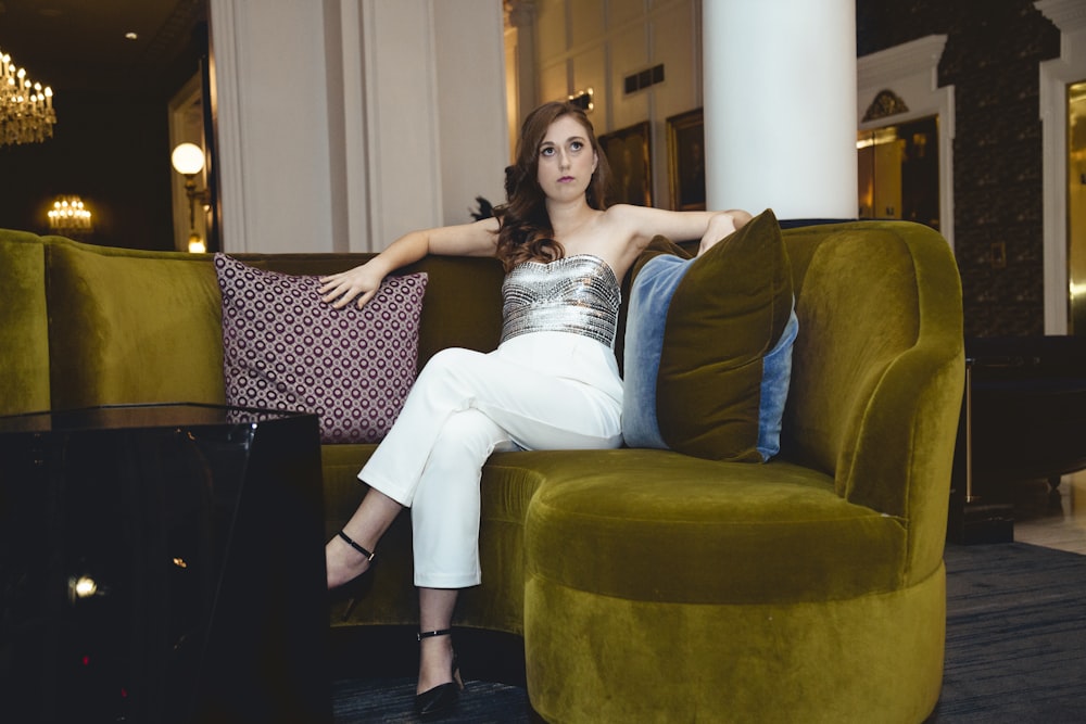 woman in white dress lying on couch