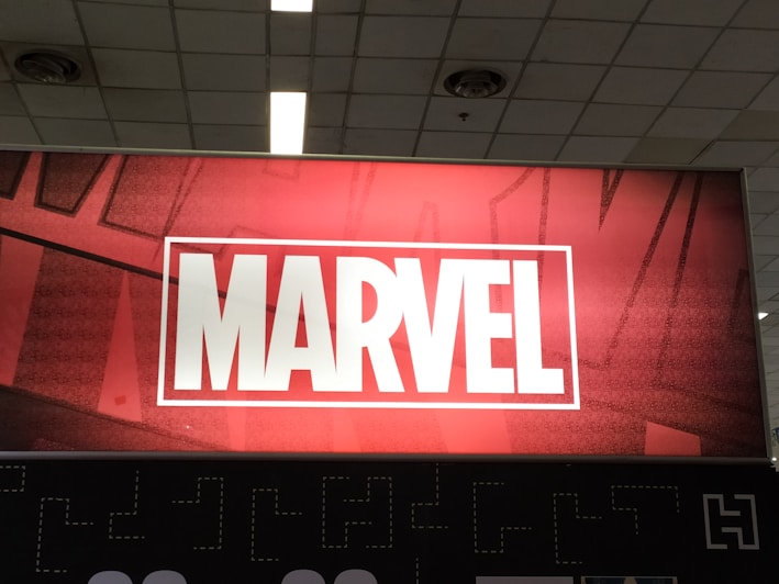 A sleek, dark-themed card featuring the Marvel logo glowing with a subtle turquoise light.