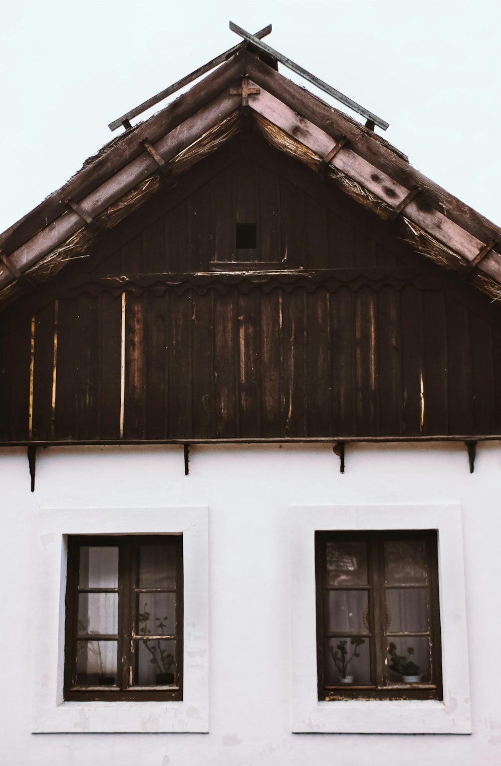 brown wooden house with white window