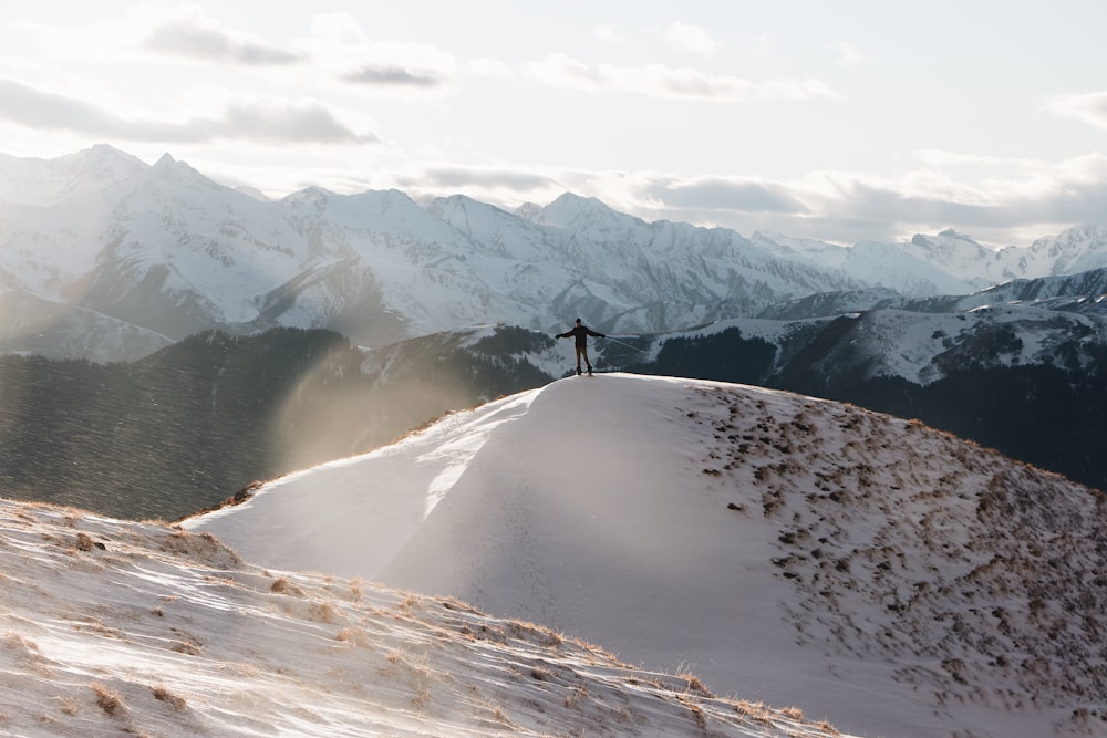 person walking on snow covered mountain during daytime