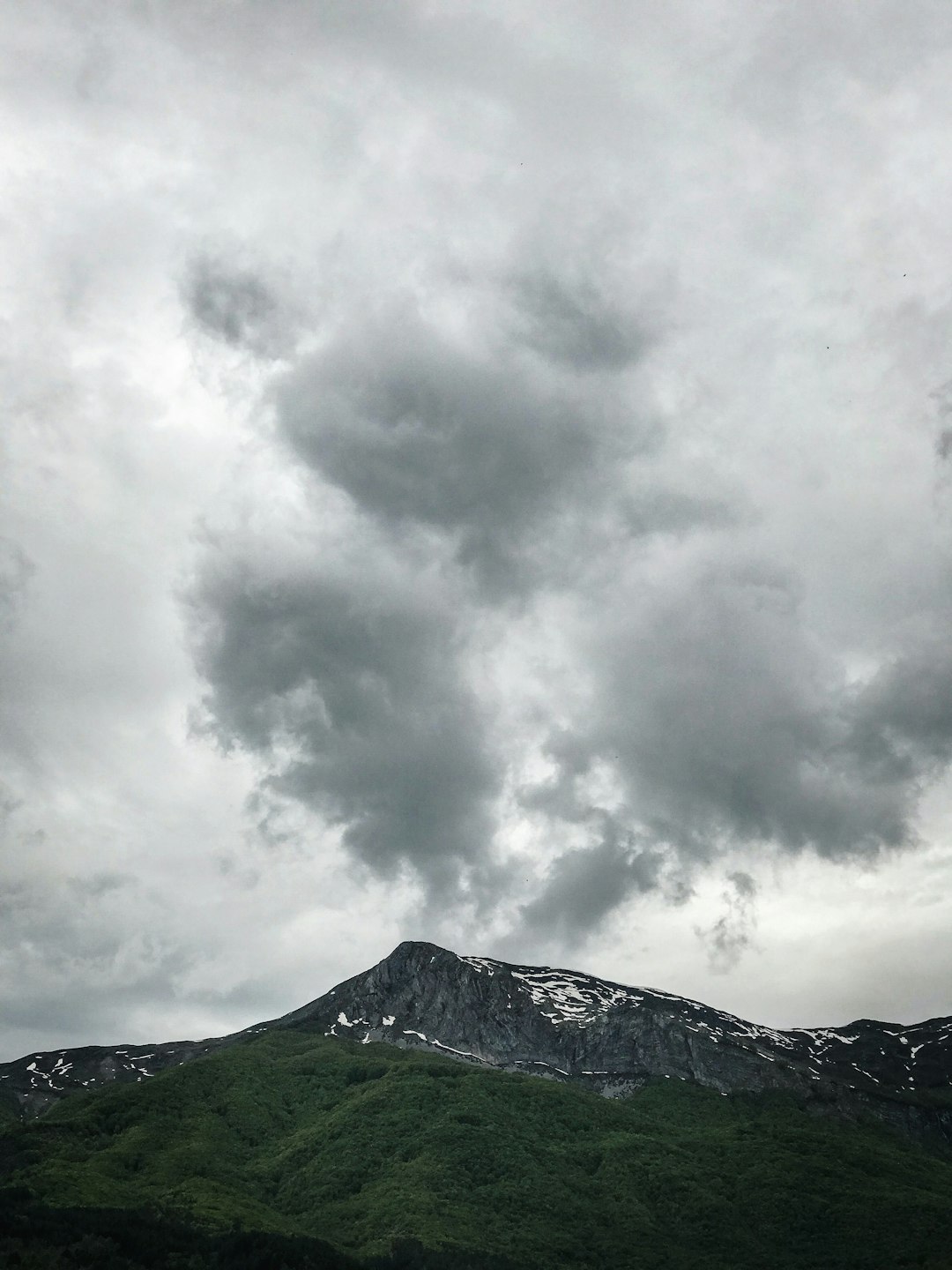 green mountain under white clouds during daytime