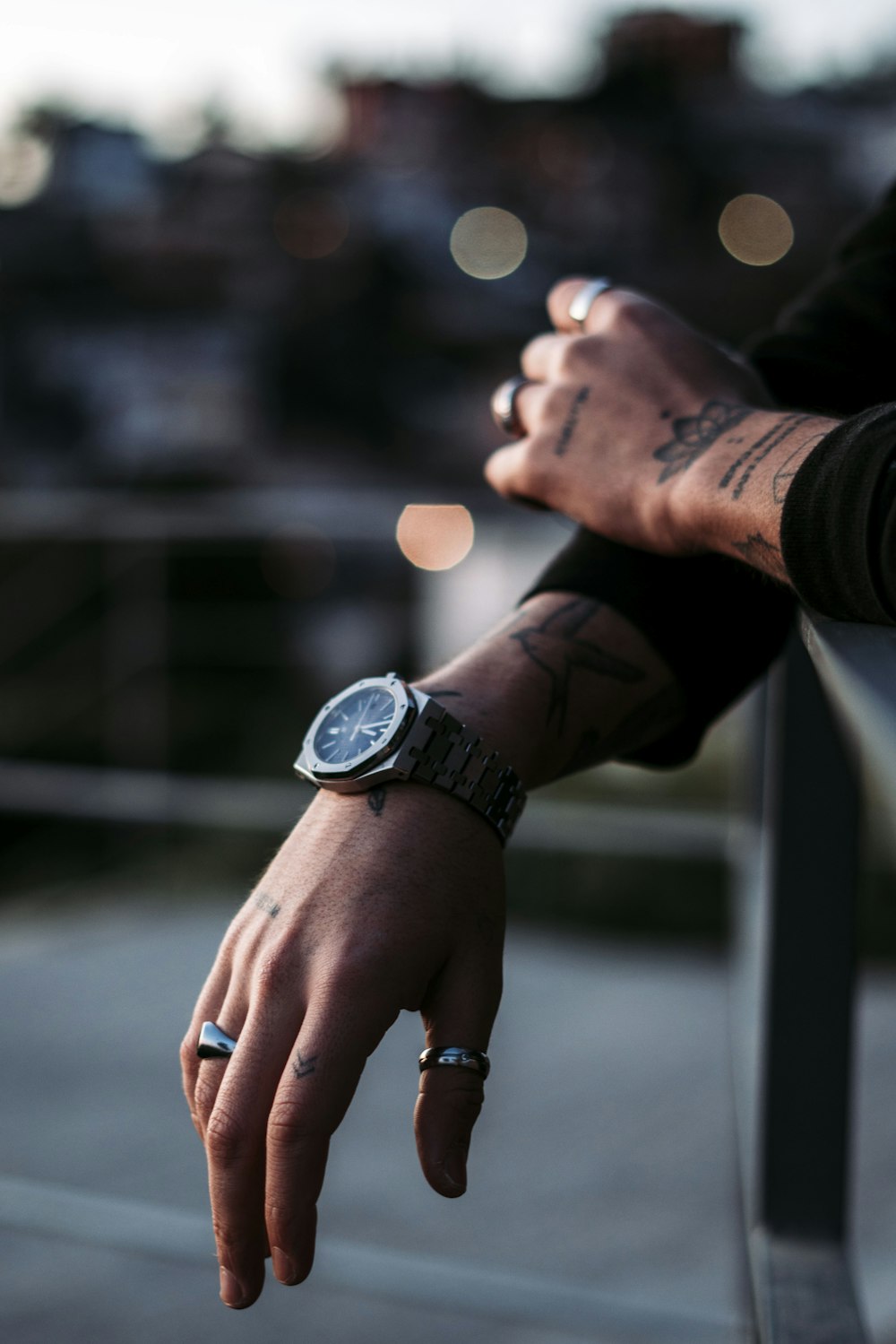 person wearing black and silver chronograph watch