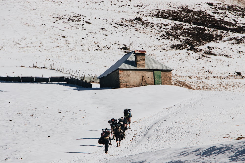 people walking on snow covered ground during daytime