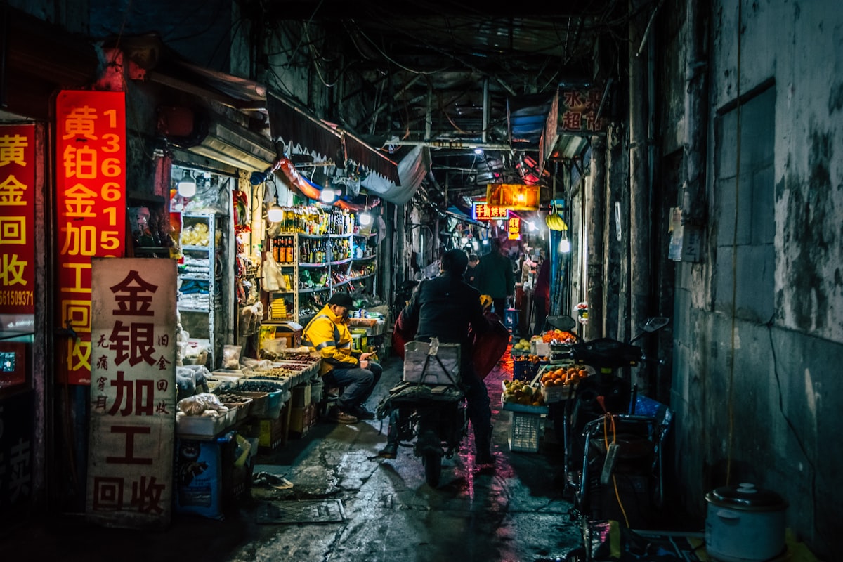 A man riding through a local marketplace