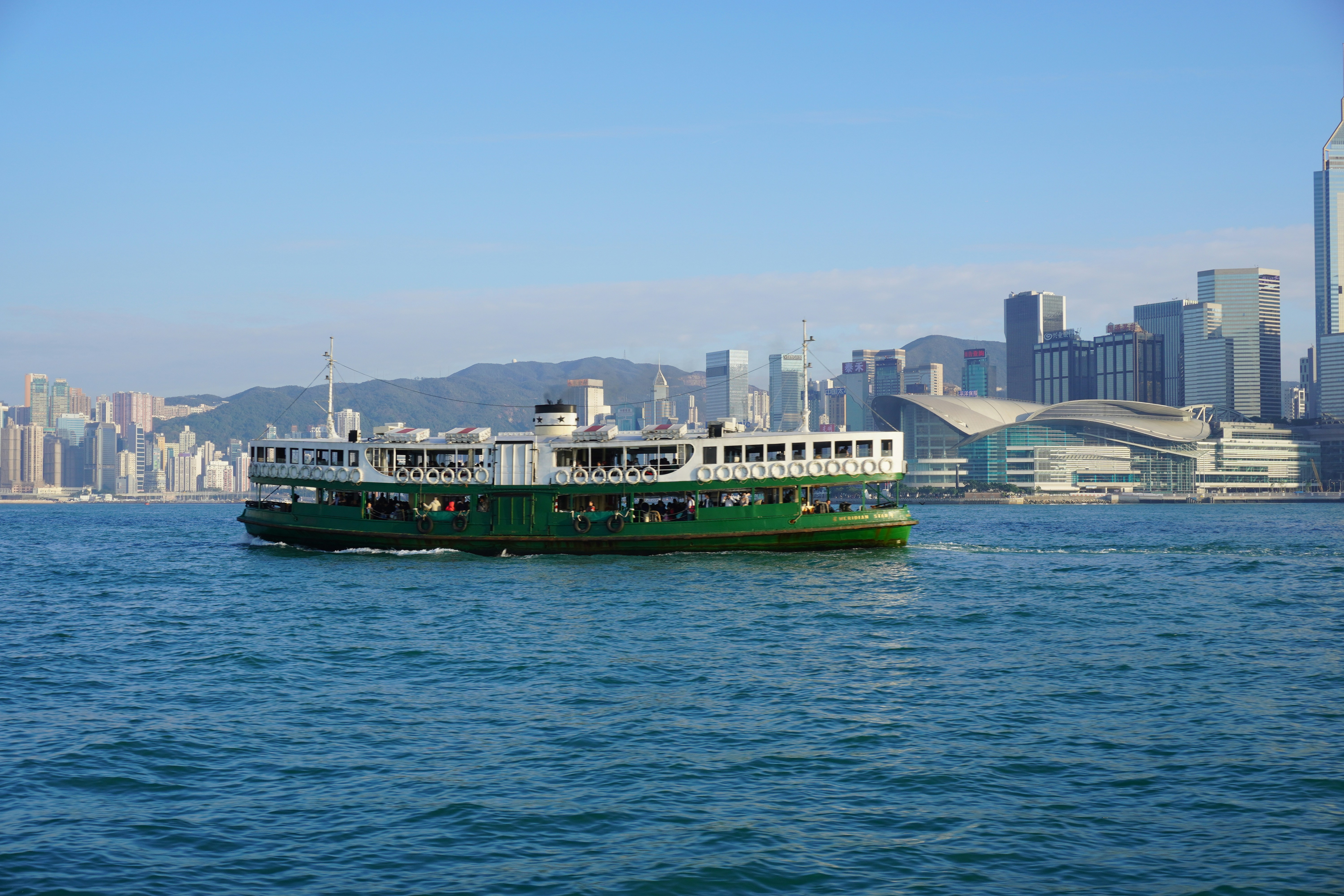 green and white ship on sea during daytime