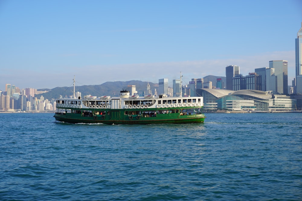 green and white ship on sea during daytime